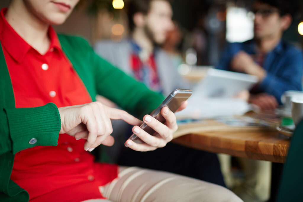 Restaurant CRM For Dummies showing a person in a restaurant on his mobile phone